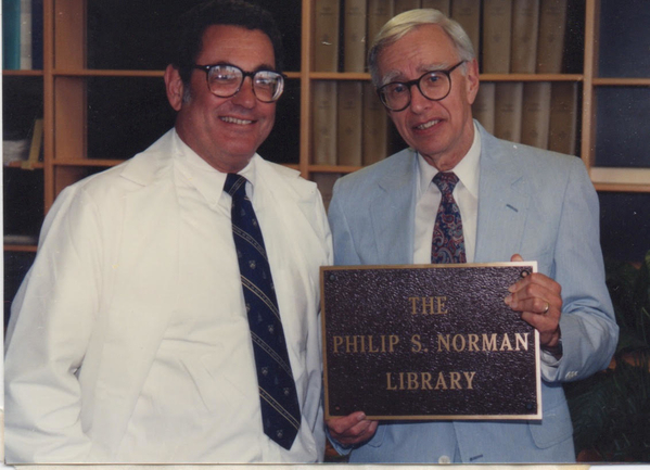 Dr. Lichtenstein and Dr. Norman holding the plaque for the Philip S. Norman Library at the Johns Hopkins Asthma and Allergy Center in Baltimore