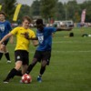 Leo Adams, a teen with asthma in a yellow jersey, playing soccer with another young man in a blue jersey: Leo Adams, a teen with asthma in a yellow jersey, playing soccer with another young man in a blue jersey